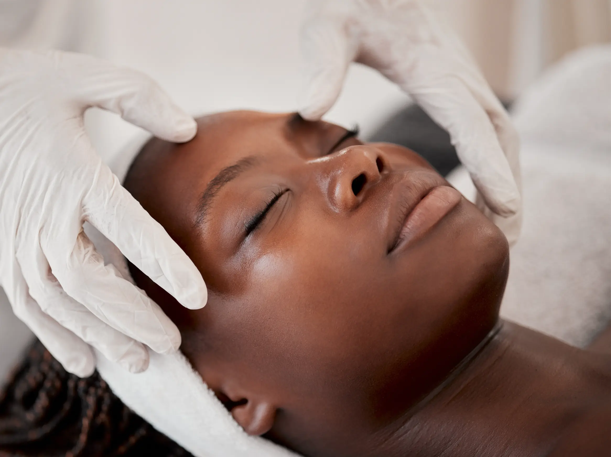 A client relaxes during a dermaplaning session. This gentle and effective treatment removes surface debris and fine hairs, leaving the skin feeling refreshed and rejuvenated.