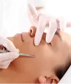 A client receiving dermaplaning, a non-invasive facial treatment to exfoliate the skin by removing dead skin cells and fine vellus hair, resulting in a smoother, clearer, and more radiant appearance at La Maison Beauté.