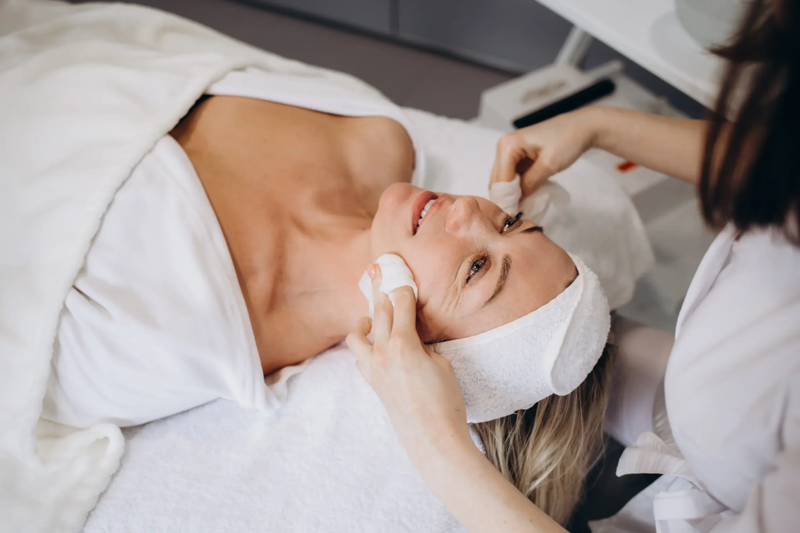 A client enjoys personalized facial treatments at La Maison Beauté, where a skilled aesthetician is carefully cleansing her skin. This step is essential for maximizing the benefits of the treatment and revealing her natural beauty.