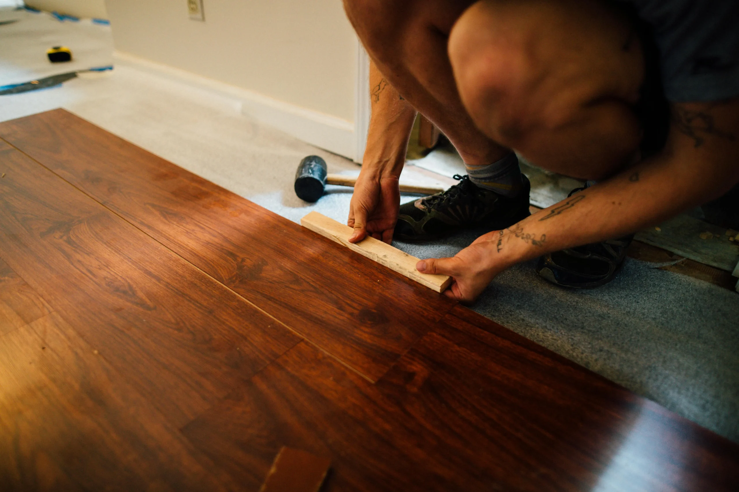 A technician Installing Floors a room with the tools he used in installing.